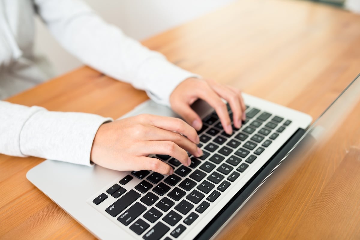 Woman working on laptop computer at home