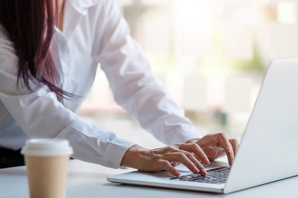 Close up of female hands on a laptop keyboard