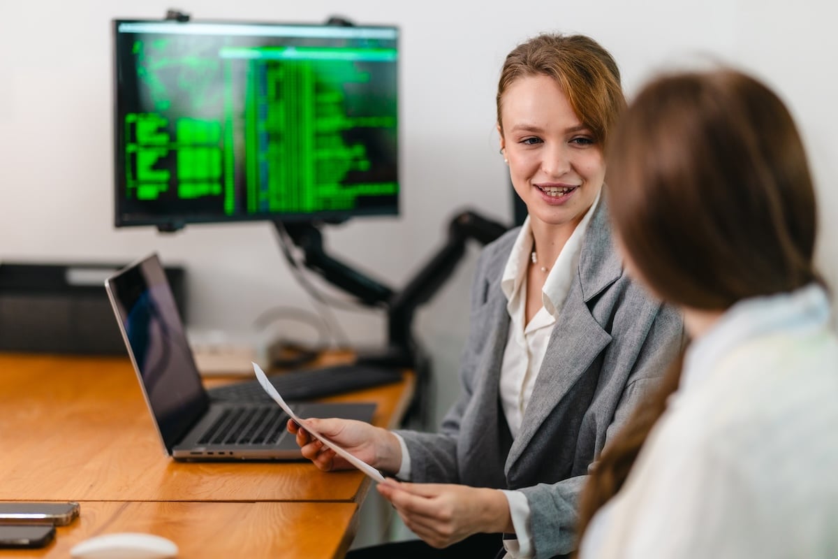 Web accessibility consultant reviewing report with web designer.